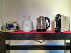 a counter with a coffee maker and a toaster on it at Pisa Train Stop in Pisa