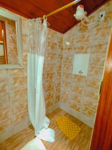 a bathroom with a shower with a shower curtain at Quarto Maringá Minas in Bocaina de Minas