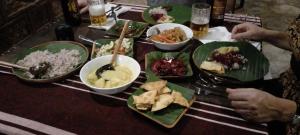 a table with plates of food and bowls of rice at Loveena by H.S. Restaurant & Guest in Tangalle