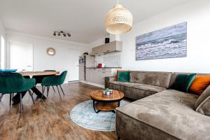 a living room with a couch and a table at De Schelp 85 in Zandvoort