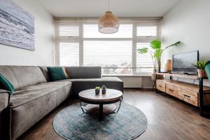 a living room with a couch and a coffee table at De Schelp 85 in Zandvoort