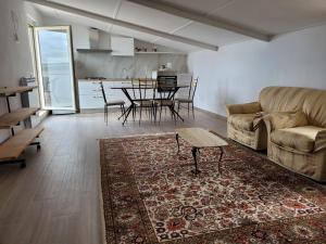 a living room with a couch and a table at Casa Vacanze Maurella in Marconia +20 photos