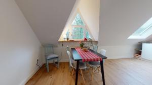 a dining room with a table and chairs in a attic at Löningen - Ferienwohnung Hasestraße in Löningen