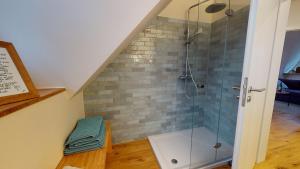 a bathroom with a shower with a glass shower stall at Löningen - Ferienwohnung Hasestraße in Löningen +6 photos