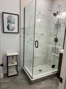 a shower with a glass door in a bathroom at Spacious Apartment in Boston in Boston