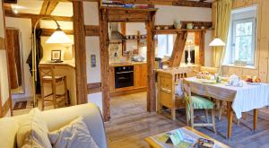 a kitchen and dining room with a table in a room at Remparts de Riquewihr - Le Renard & les Raisins in Riquewihr
