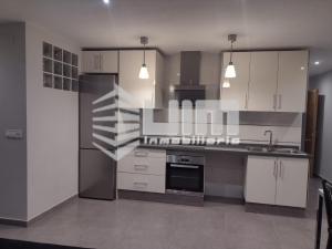 a kitchen with white cabinets and stainless steel appliances at UIM Mediterraneo ATICO Hispanidad 3 Wifi in Puerto de Sagunto +5 photos