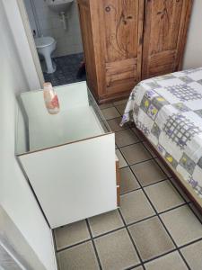 a room with a bed and a white cabinet at Pituba quartos in Salvador