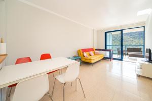 een woonkamer met een witte tafel en stoelen bij Beach and Green in Alicante