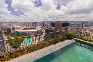 a swimming pool on the roof of a building at Vossa Bossa Allianz in São Paulo