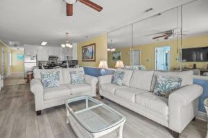 a living room with two couches and a table at Lighthouse II Unit 6 in Myrtle Beach