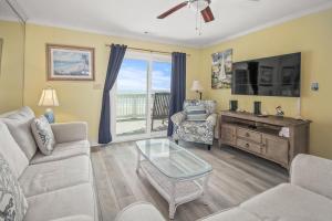 a living room with a couch and a tv at Lighthouse II Unit 6 in Myrtle Beach