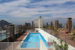 a swimming pool on the roof of a building at VIP Apartments Chile in Santiago