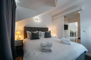a bedroom with a large white bed with towels on it at BOUTIQUE APARTMENTS IMOTSKI, Imotski - Makarska in Imotski