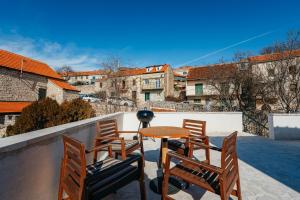 a patio with a table and chairs on a balcony at BOUTIQUE APARTMENTS IMOTSKI, Imotski - Makarska in Imotski