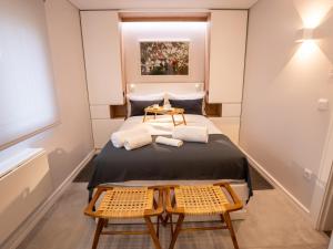 1 dormitorio pequeño con 1 cama y 2 sillas en Quinta Lourena - Casa do Caseiro en Covilhã