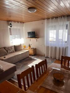a living room with a couch and a table at Apartman Luka in Jahorina