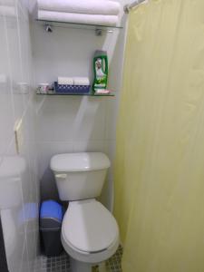 a small bathroom with a toilet and a shower at Casa Ixchel - 450m to Downtown, WiFi, Hot Water, AC in Valladolid