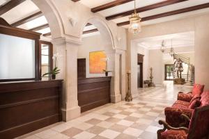 a living room with a lobby with a couch and a window at Castillo Hotel Son Vida, a Luxury Collection Hotel, Mallorca - Adults Only in Palma de Mallorca