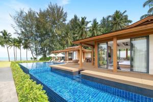 an infinity pool in front of a villa at JW Marriott Khao Lak Resort and Spa in Khao Lak