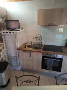 a kitchen with a laptop on top of a counter at La maison D'Orée in Polignac