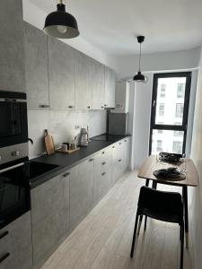 a kitchen with a table and a stove top oven at Urban Flats in Bucharest