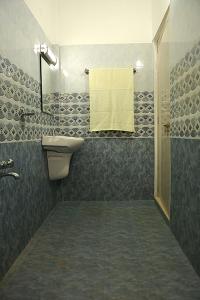 a bathroom with a sink and a shower at Aleenas homestay in Cochin