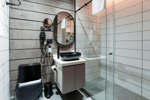 a bathroom with a sink and a mirror at Hotel Living by Armoniko in Medellín +58 photos