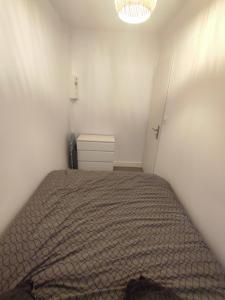 a bedroom with a bed and a chandelier at Les Mégalithes in Sète