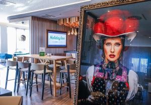 a picture of a woman in a mirror in a restaurant at Holiday Inn - Villingen - Schwenningen, an IHG Hotel in Villingen-Schwenningen
