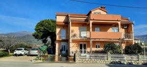 a house with cars parked in front of it at Apartman Anita in Kaštela