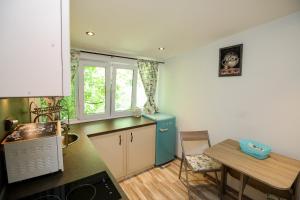 a kitchen with a blue refrigerator and a table at Charming loft, very good located! in Sofia