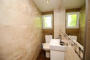 a bathroom with a toilet and a sink at Charming loft, very good located! in Sofia