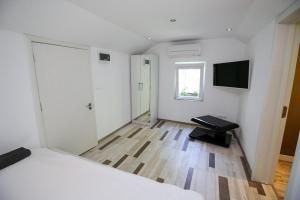 a bedroom with a bed and a television on the wall at Charming loft, very good located! in Sofia