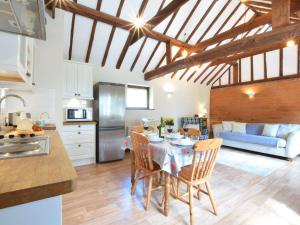 a kitchen and dining room with a table and chairs at The Stables in Colchester