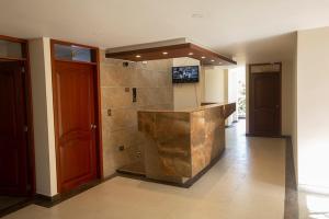 Hotel Explora في Chachagüí: مطبخ مع كونتر وتلفزيون على الحائط