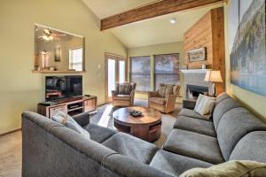 a living room with a couch and a table at Pagosa Springs Getaway with Patio and Lake Views! in Pagosa Springs
