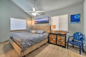 a bedroom with a bed and a blue chair at Pagosa Springs Getaway with Patio and Lake Views! in Pagosa Springs