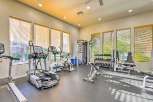 a gym with treadmills and machines in a room with windows at Upscale Scottsdale Getaway with Golf Course Views! in Scottsdale