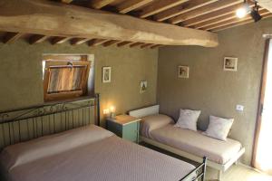 a bedroom with two beds and a mirror at I SEI FILARI in Capannori
