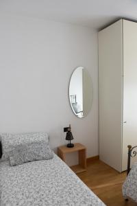 1 dormitorio con cama y espejo en Pelèr13, en Riva del Garda