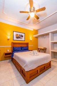 a bedroom with a large bed with a ceiling fan at Alquería Central hotel in Tlaxco de Morelos