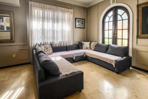 a living room with a couch and a window at Luxurious San Juan Villa with Pool - Walk to Beach! in San Juan