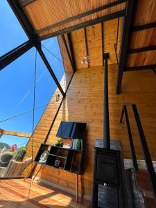 Cabana Cambará في كامبارا: غرفة معيشة مع موقد خشب في منزل