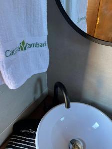 a white toilet in a bathroom with a mirror at Cabana Cambará in Cambará