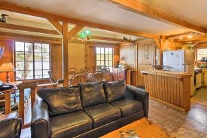 a living room with a couch and a kitchen at Cozy Stop Island Cabin with Boat Dock and Beach! in International Falls