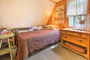 a bedroom with a bed and a dresser and a window at Cozy Stop Island Cabin with Boat Dock and Beach! in International Falls