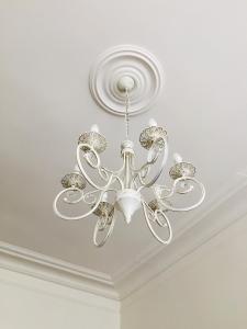 a silver chandelier hanging from a ceiling at Appartement Marais in Paris