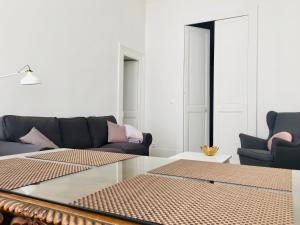 a living room with a couch and a glass table at Appartement Marais in Paris