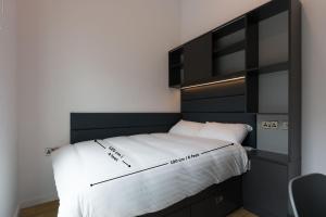 a bedroom with a bed with a black headboard at Destiny Student - Dominick Place in Dublin